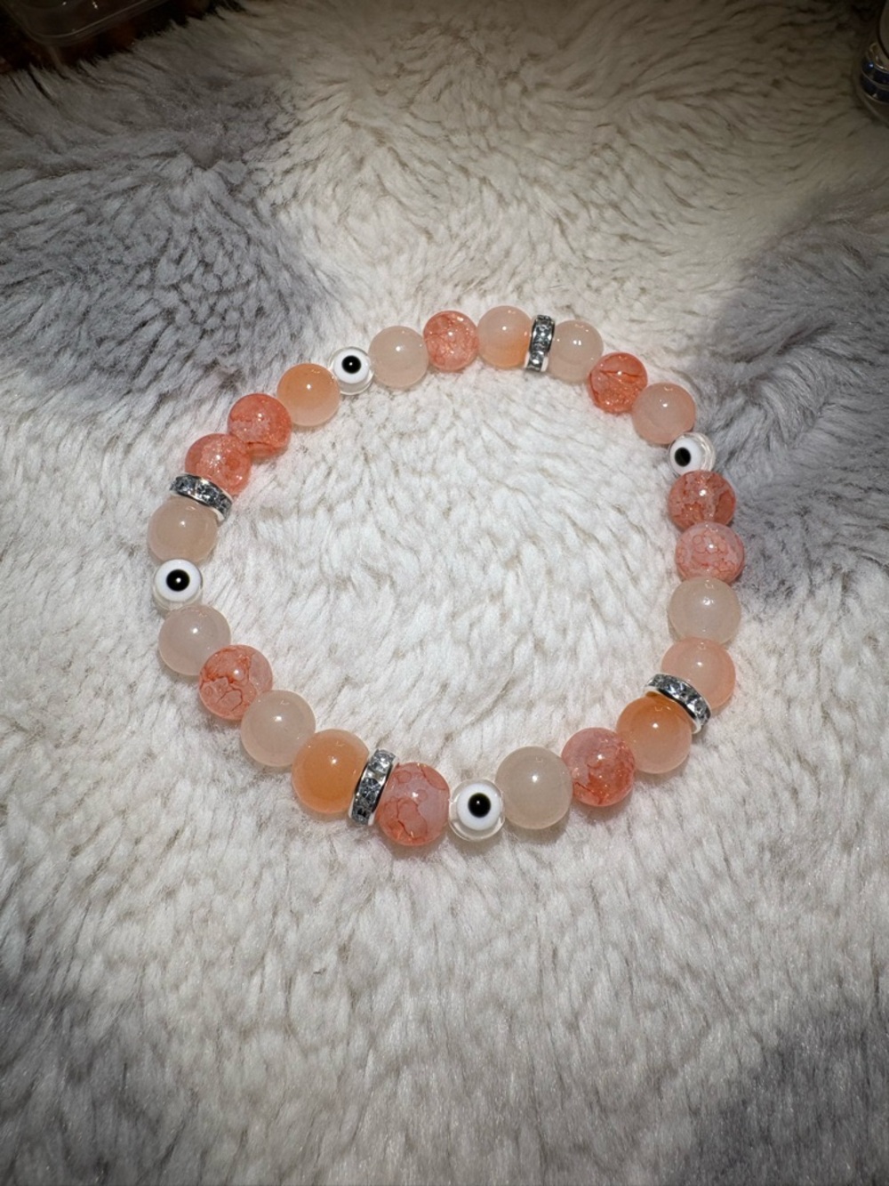 Peach Glass Bead Stretch Bracelet with white Evil Eye Accents